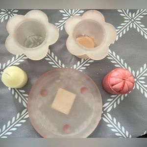 2 pink flower candle holders and plate with candles